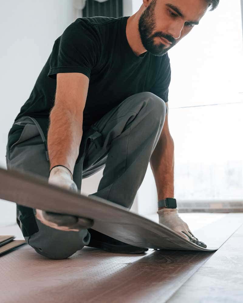 Man installing wooden floor planks